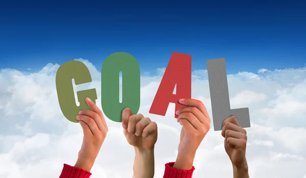 Hands showing goal against blue sky — Stock Photo, Image