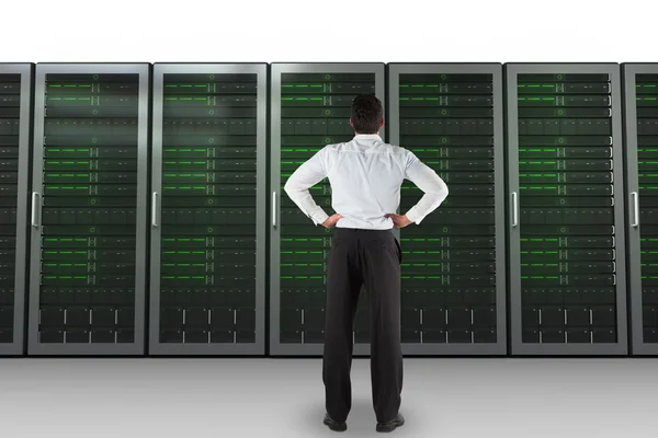 Businessman against server towers — Stock Photo, Image