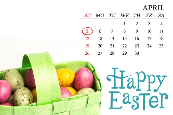 Speckled easter eggs in a green basket — Stock Photo, Image