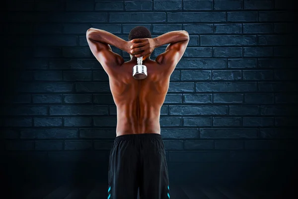 Imagen compuesta de la vista trasera de un hombre sin camisa en forma levantando mudo — Foto de Stock