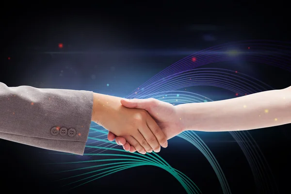 Composite image of handshake between two women — Stock Photo, Image