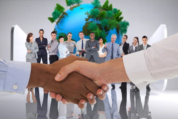 Composite image of close-up shot of a handshake in office — Stock Photo, Image