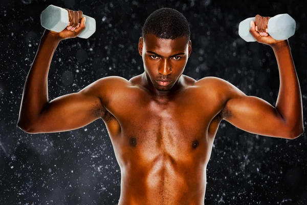 Composite image of determined fit shirtless man lifting dumbbell — Stock Photo, Image