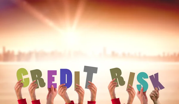 Hands holding up credit risk against sun shining — Stock Photo, Image