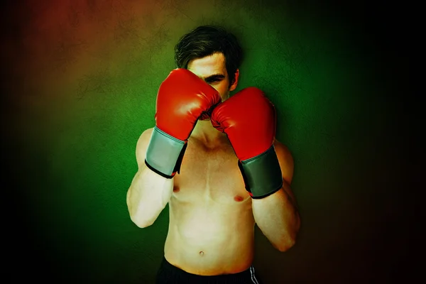 Homem musculoso vestindo luvas de boxe vermelho — Fotografia de Stock