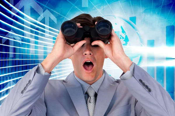 Suprised businessman looking through binoculars — Stock Photo, Image