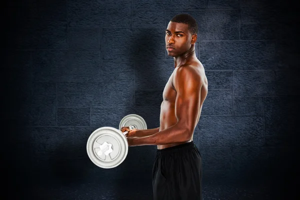 Composite image of portrait of a serious fit young man lifting b — Stock Photo, Image