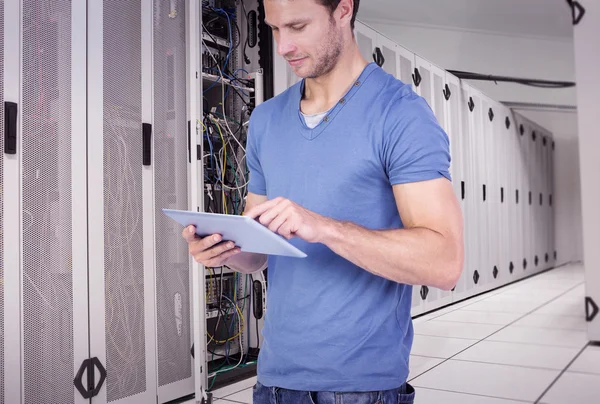 Man scrolling through tablet pc against data center — Stock Photo, Image