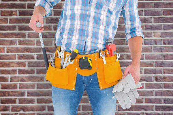 Handyman holding hammer and gloves — Stock Photo, Image