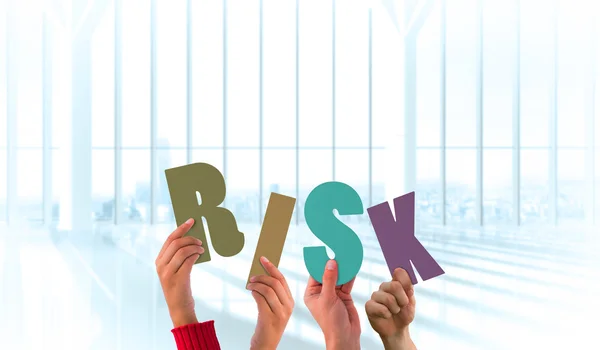 Hands holding up risk against large window — Stock Photo, Image