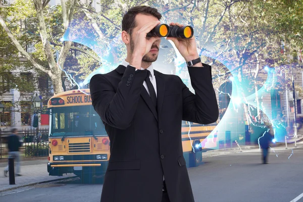 Elegant businessman standing and using binoculars — Stock Photo, Image