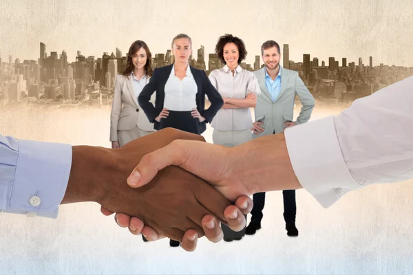 Composite image of close-up shot of a handshake in office — Stock Photo, Image