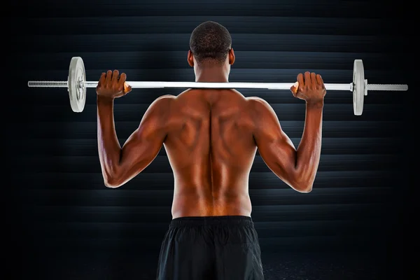 Composite image of rear view of a fit shirtless man lifting barb — Stock Photo, Image