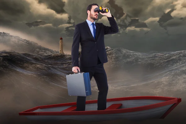 Businessman in boat with binoculars against stormy sea — Stock Photo, Image