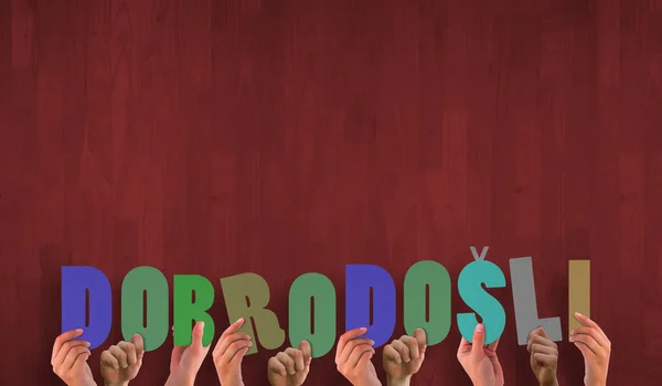 Hands holding up dobrodosli — Stock Photo, Image