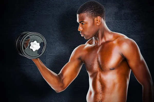 Composite image of serious fit shirtless young man lifting dumbb — Stock Photo, Image