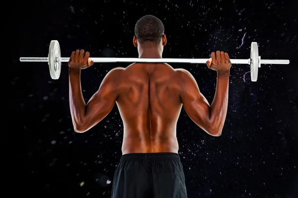 Rear view of a fit shirtless man lifting barbell — Stock Photo, Image