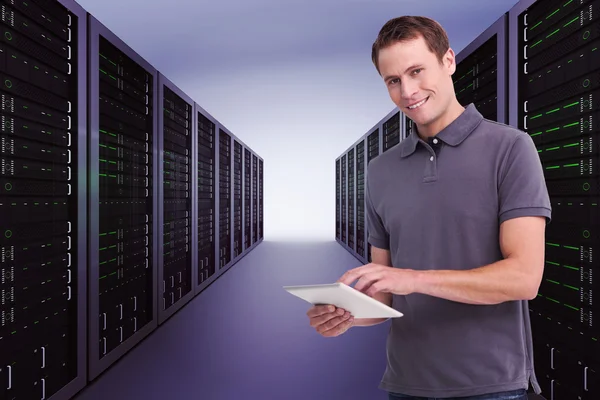 Smiling young man with tablet computer Stock Image