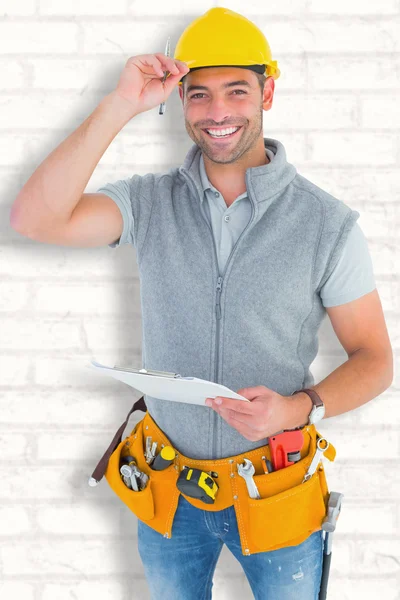 Smiling manual worker holding clipboar — Stock Photo, Image