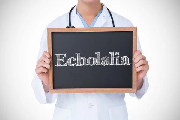 Echolalia against doctor showing blackboard — Stock Photo, Image