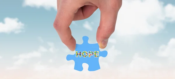 Hand holding jigsaw piece — Stock Photo, Image