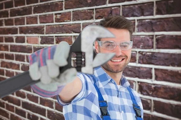 Confident repairman holding wrench — Stock Photo, Image