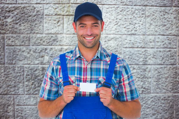 Handyman holding visiting card — Stock Photo, Image