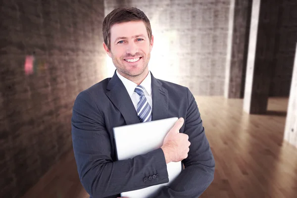 Businessman holding his laptop tightly — Stock Photo, Image