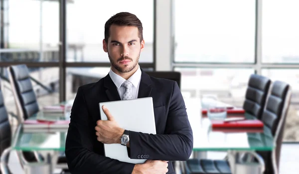 Empresario en traje posando con portátil — Foto de Stock