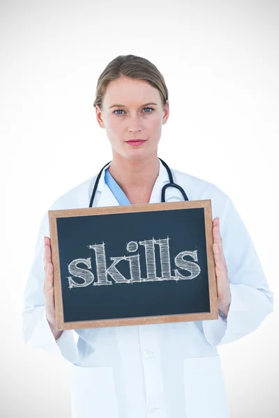 Skills against doctor showing chalkboard — Stock Photo, Image