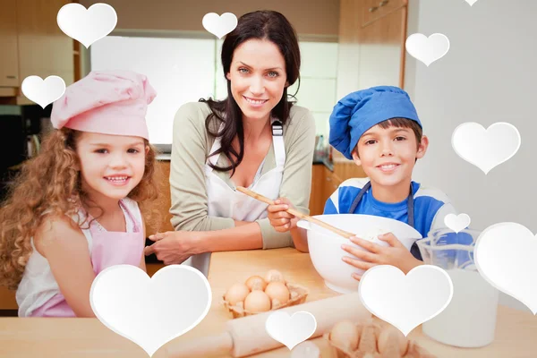 Mor och hennes barn förbereder tårta — Stockfoto