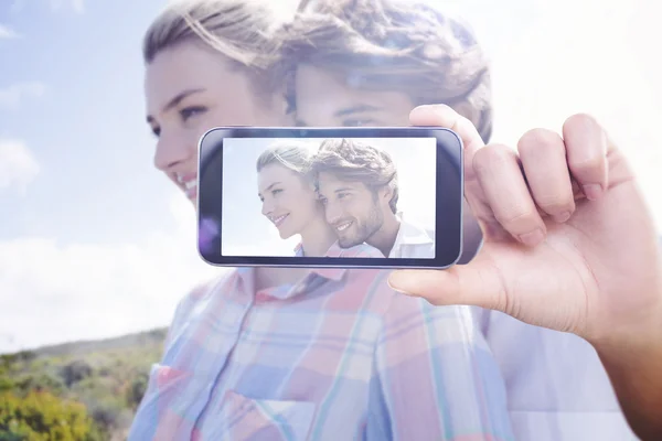 Imagem composta de mão segurando smartphone — Fotografia de Stock