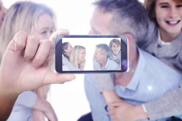 Imagem composta de mão segurando smartphone mostrando — Fotografia de Stock