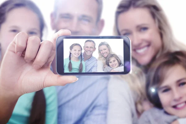 Composite image of hand holding smartphone showing — Stock Photo, Image