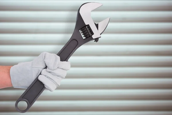 Mechanic holding spanner — Stock Photo, Image