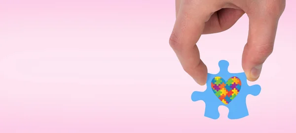 Hand holding jigsaw piece — Stock Photo, Image