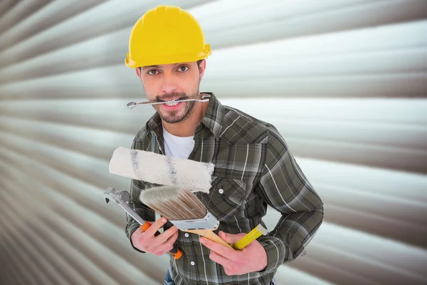 Manual worker holding various tools — Stock Photo, Image