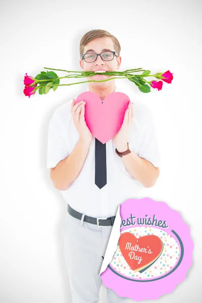 Composite image of geeky hipster holding red roses and heart car — Stock Photo, Image