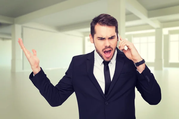 Angry businessman gesturing on phone — Stock Photo, Image