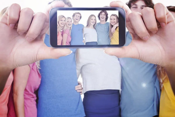 Composite image of hand holding smartphone — Stock Photo, Image