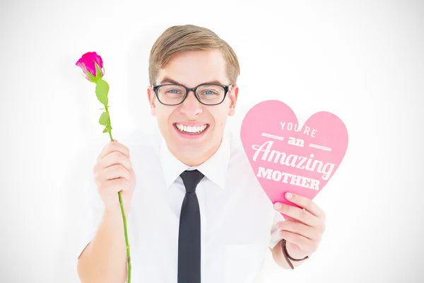 Composite image of geeky hipster holding a red rose and heart ca — Stock Photo, Image