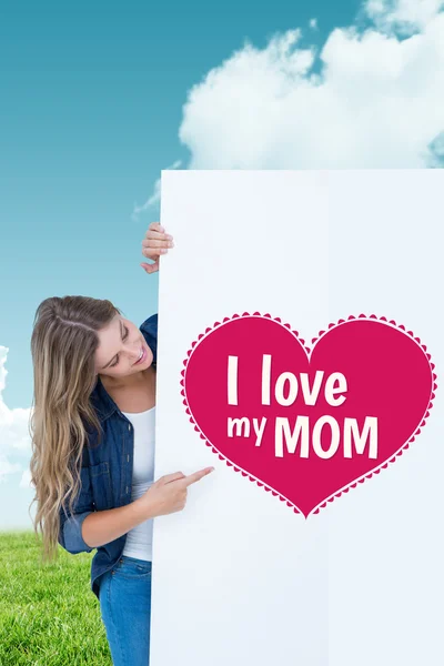 Composite image of woman showing poster — Stock Photo, Image