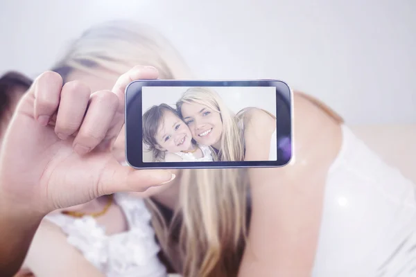 Composite image of hand holding smartphone showing — Stock Photo, Image