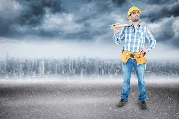 Thoughtful worker carrying wooden planks — Stock Photo, Image