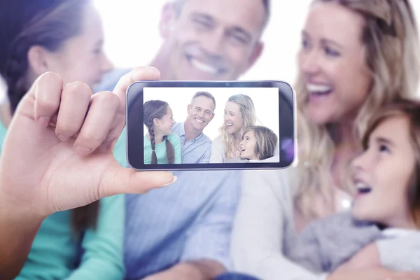 Composite image of hand holding smartphone showing — Stock Photo, Image