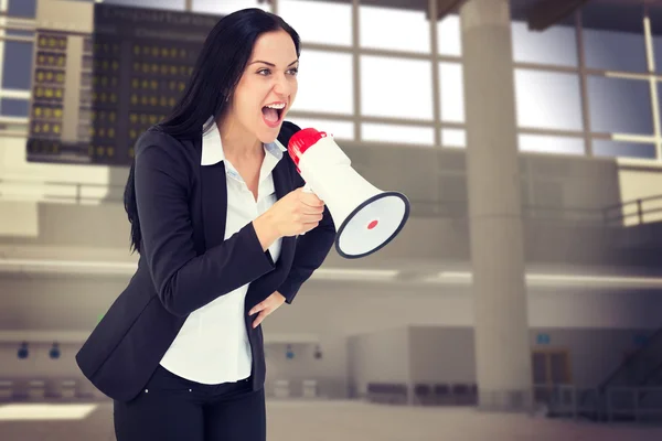 Businesswoman shouting with megaphone — Stock Photo, Image