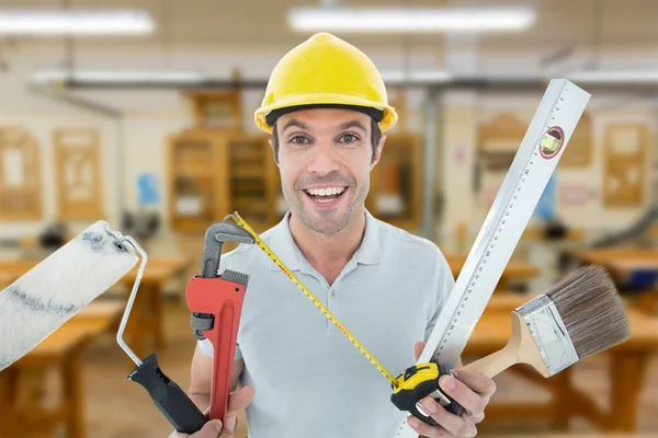 Worker holding various equipment — Stock Photo, Image