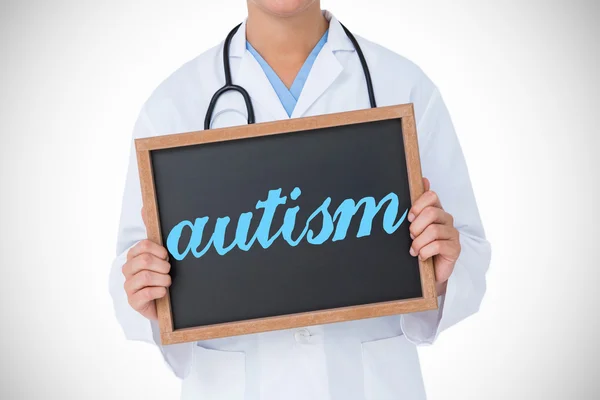 Autism against doctor showing little blackboard — Stock Photo, Image