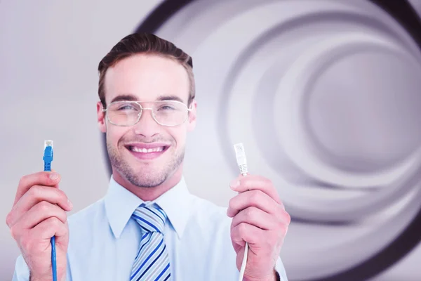 Businessman holding two cables — Stock Photo, Image