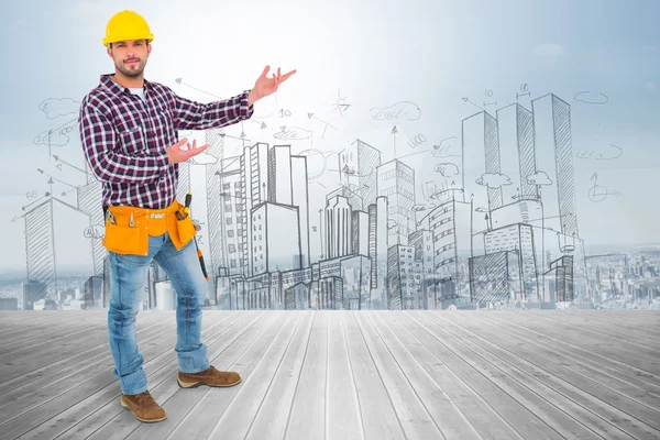 Handyman showing something against room — Stock Photo, Image